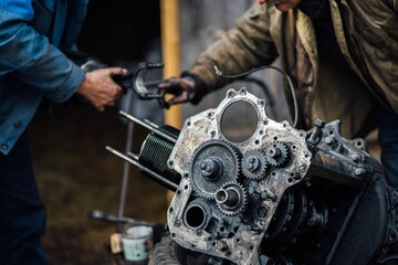 car engine repair, installation of new pistons in cylinders.