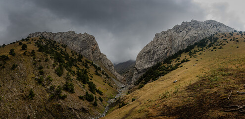 A footpath through a massive rock pass in the Turkestan Mountains.
