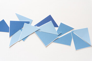 blue triangles of various shapes scattered on blank paper