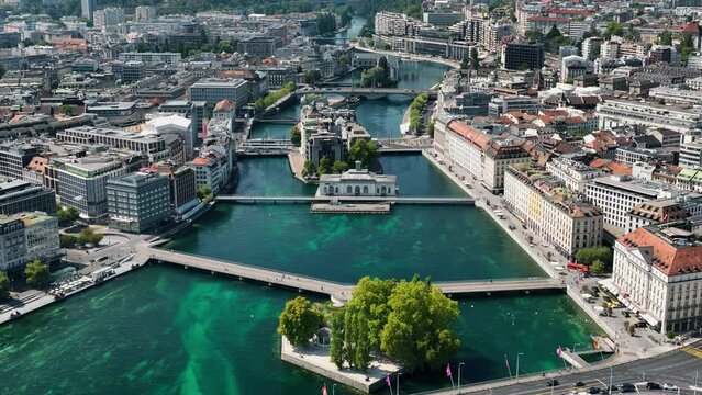 Flight over sunny geneva central cityscape lakeside fountain rooftop aerial panorama 4k switzerland