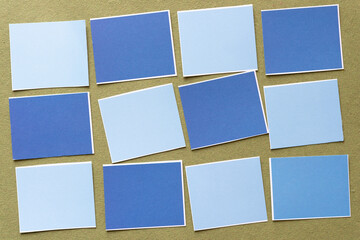 light and dark blue paper tile shapes on green