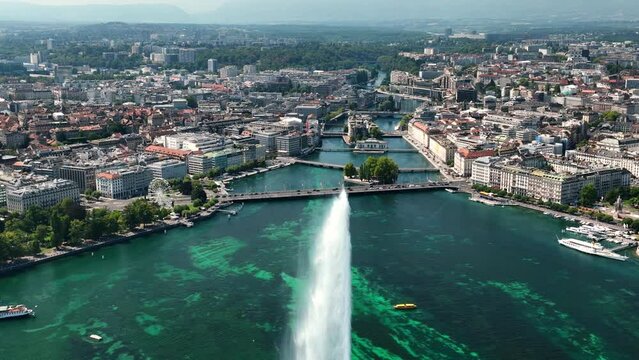 Flight over sunny geneva central cityscape lakeside fountain rooftop aerial panorama 4k switzerland