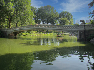 Fototapeta na wymiar Ornate foot bridge over the lake in NYC Central Park