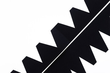 cut black paper shapes with zig zag elements on white
