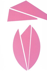 elegant cut pink paper shapes on a white background