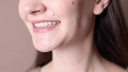 A young girl uses aligners to straighten her teeth