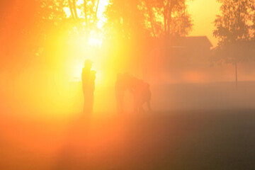 Family playing in the early morning fog