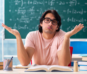 Young male student in the classroom
