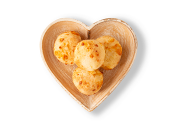 Cheese bread (Brazilian pao de queijo mineiro), top view, transparent png background, heart shaped plate