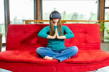 Adult woman practicing meditation and yoga with the help of a viewer for virtual reality