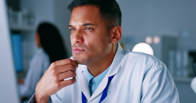 Man, scientist and thinking in research on computer for healthcare breakthrough or discovery in laboratory. Thoughtful and serious male doctor wondering or contemplating science working on PC in lab