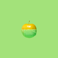 Create fruits dipped in green color. Delicious sweet apple on a pastel background.. Minimal food concept..