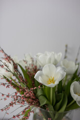 Fototapeta na wymiar Beautiful spring bouquet with seasonal flowers in interior