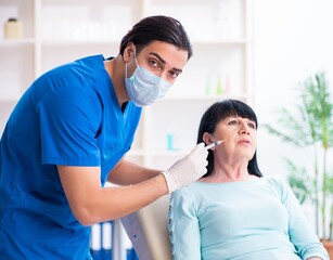 Old woman visiting male doctor for plastic surgery