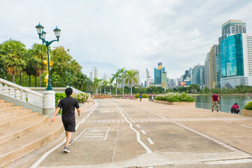 People walking at Park with Cityscape view of Lake.