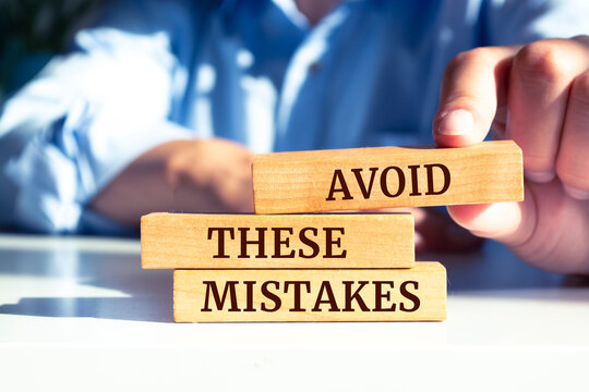 Wooden blocks with words 'Avoid These Mistakes'. Business concept