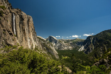 Fototapeta na wymiar Yosemite Falls and Half Dome Tower Over Yosemite Valley