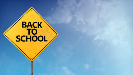 Back to School Road Sign Blue Skies features a yellow caution sign that reads Back to School with clouds in a blue sky.