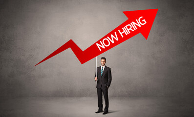 Fototapeta premium Young business person in casual holding road sign