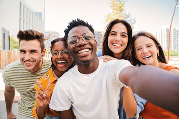 Fototapeta Group of multiracial young student people smiling and taking a selfie together. Close up portrait of happy african american teenager laughing with his cheerful friends. Classmates on friendly meeting obraz