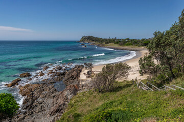 Fototapeta na wymiar Steps leading down to rocky beach - Pebbly Beach, Forster, NSW, Australia
