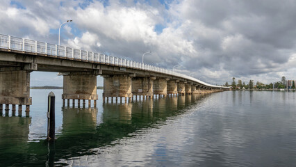 Fototapeta na wymiar Forster Tuncurry Bridge (1959) over the Coolongolook River - one of the longest pre-stressed concrete bridges in the Southern Hemisphere - Forster, NSW, Australia