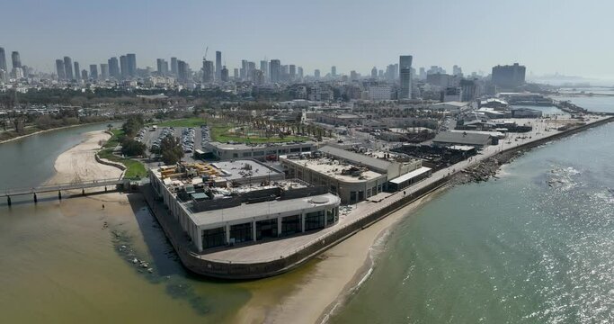 Aerial footage of the Tel Aviv Port Promenade with the Tel Aviv Ramat Gan skyline in the background. Filmed in C4K Apple ProRes 422 HQ