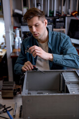 professional technician man disassembles computer. Computer service and repair concept. pc computer disassembling in repair shop. Electronic development, electronic device fixing
