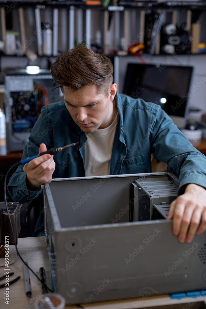 Wall mural repairs and diagnostics breakdowns of laptop in professional service center. young professional elec