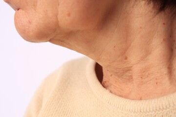 Closeup view of older woman on white background