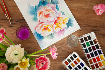 Flat lay composition with watercolor paints and floral picture on wooden table. Creative artwork