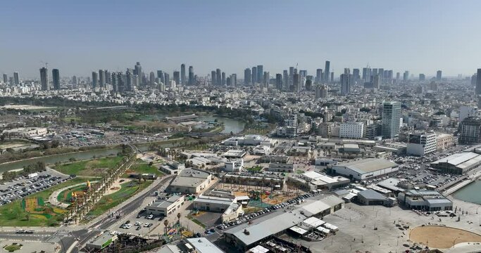 Aerial footage of the Tel Aviv Port Promenade with the Tel Aviv Ramat Gan skyline in the background. Filmed in C4K Apple ProRes 422 HQ