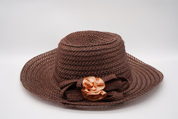 The brown knit hat has a bow tied for a beautiful look.