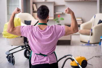 Young male contractor cleaner looking after newborn