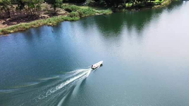 Aerial footage of a boat that strolling around a great lake