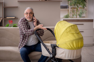 Old man looking after newborn at home