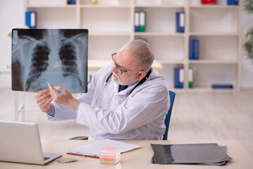 Fototapeta premium Old male doctor radiologist working in the clinic