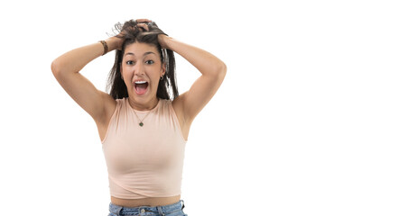 Pretty latina woman with hands on head in attitude of surprise and happiness on white background