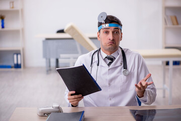 Young male doctor otolaryngologist working in the clinic