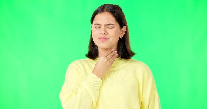 Green screen, woman and pain in throat, flu infection and suffering from cold virus in studio. Sick female model, allergies and massage neck for health risk, covid and itchy voice of thyroid problem