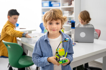 Robotics programming class. Children construct and code Robot. STEM education using constructor...
