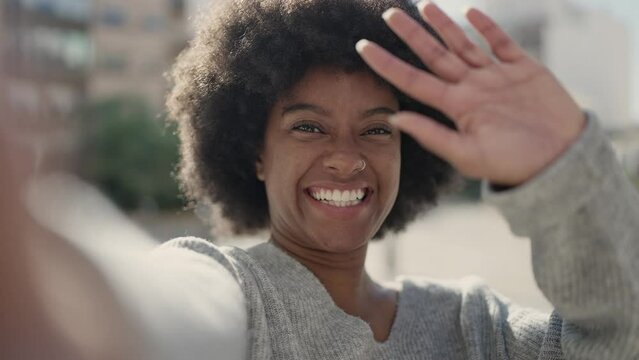 African american woman smiling confident having video call, sm at street