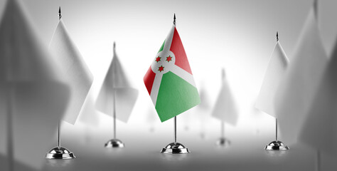 The national flag of the Burundi surrounded by white flags