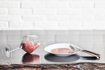 meat in a wine glass, concept idea food menu, unusual background