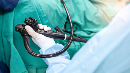A doctor or surgeon in a light blue protective gown did a colonoscopy or gastroscopy inside...