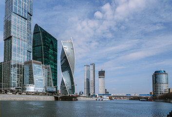 View of Skyscrapers of Moscow City district and pedestrian Bridge Bagration across the river in sunny day. Moscow. Russia