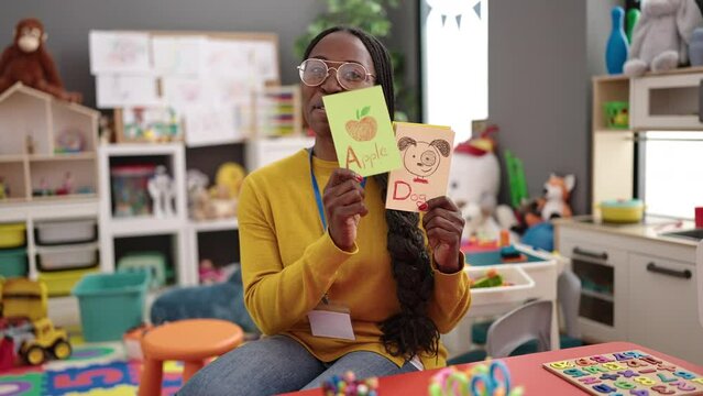 African woman preschool teacher on a vocabulary lesson at kindergarten