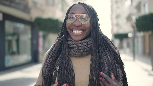 African woman smiling confident asking to come at street