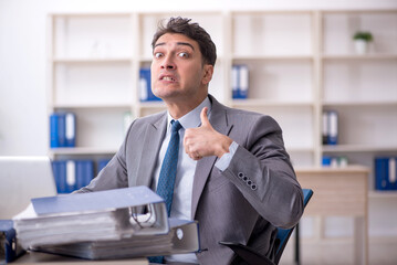 Young male employee working in the office