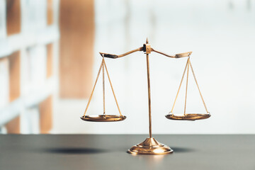 Shiny golden balanced scale in court library background as concept justice and fairness legal...